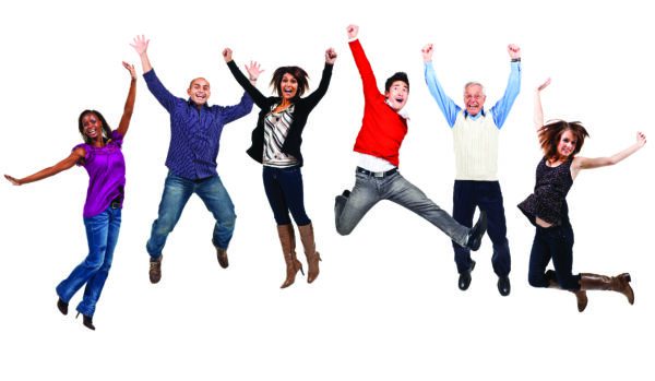 A diverse group of people jump up and down