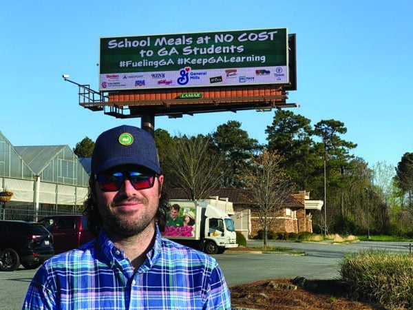 Man standing in front of billboard