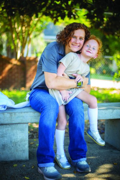 Laura Bounds with a child seated on concrete bench