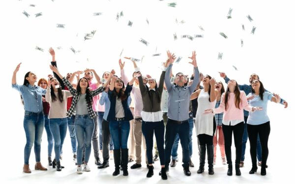 Group of people throwing money in the air