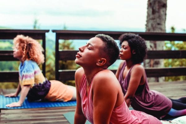 Group of women doing stretches and meditation