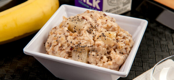 Oatmeal with pears and seeds in a white bowl