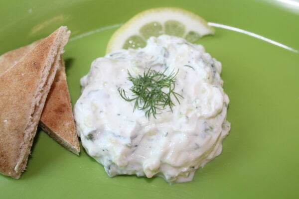 Tzatziki sauce on a green plate