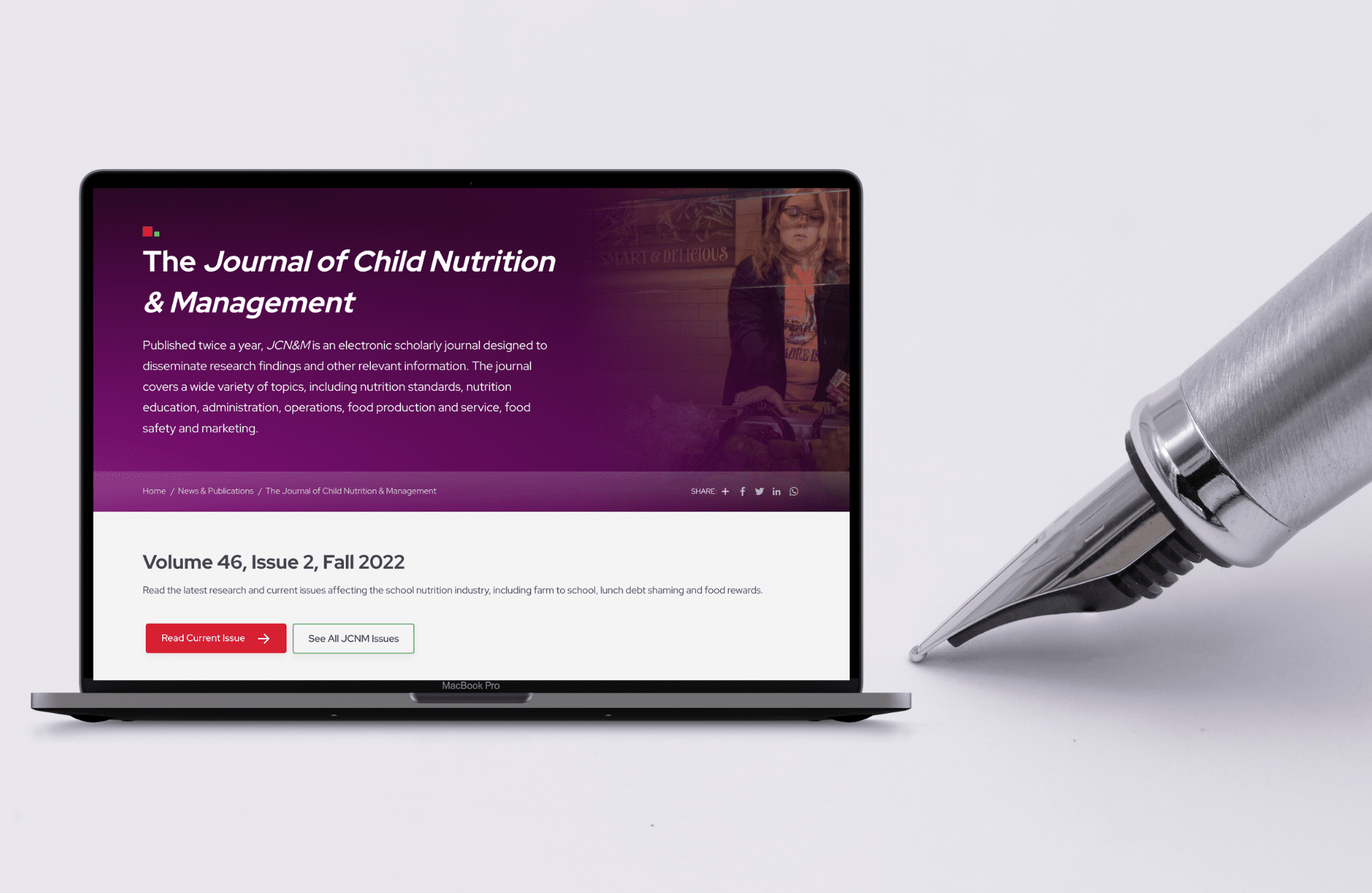 A laptop showing the Journal of Child Nutrition & Management website with a fountain pen next to it on a gray background.