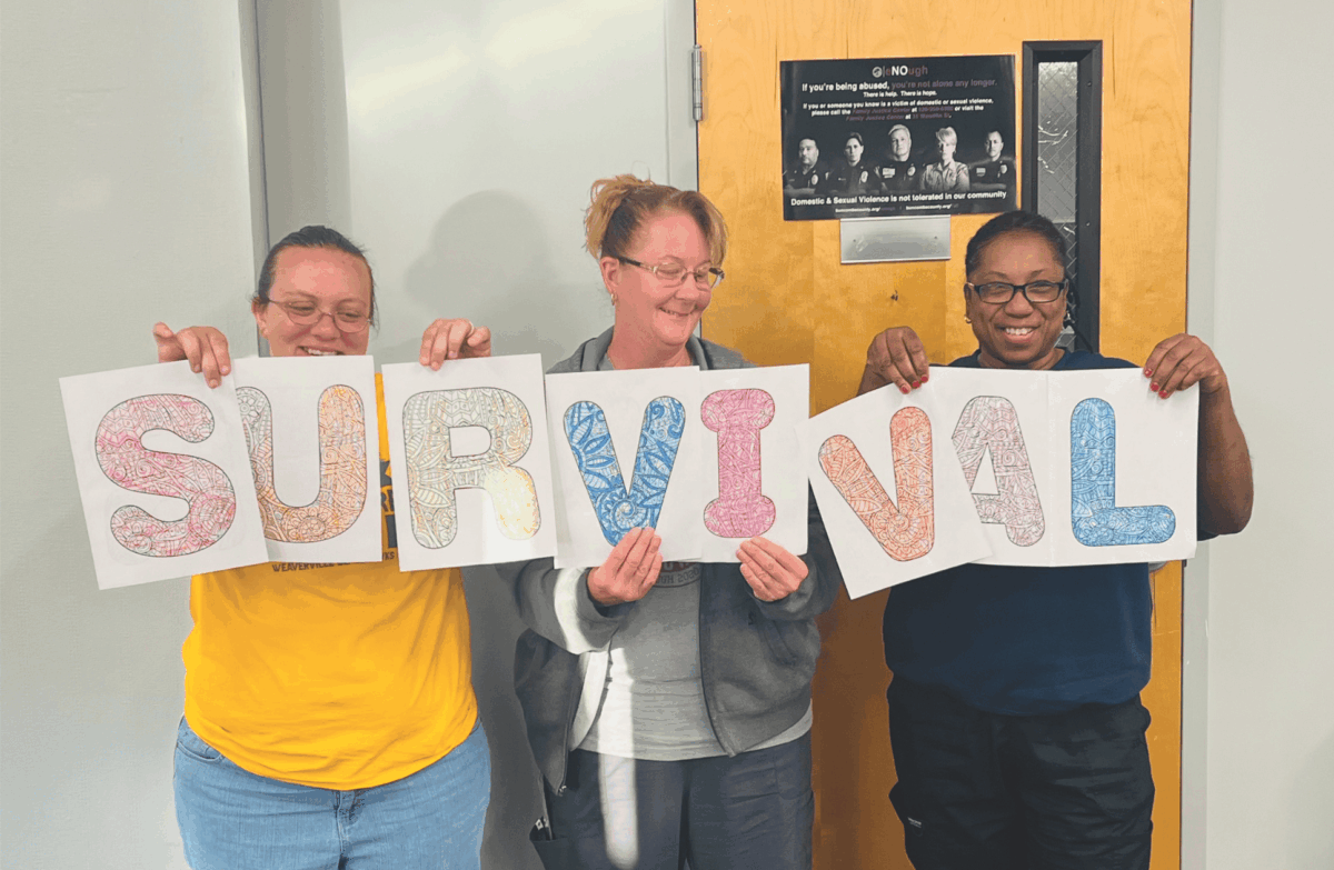 Buncombe County Schools staff holding letters that spell the word "survival"