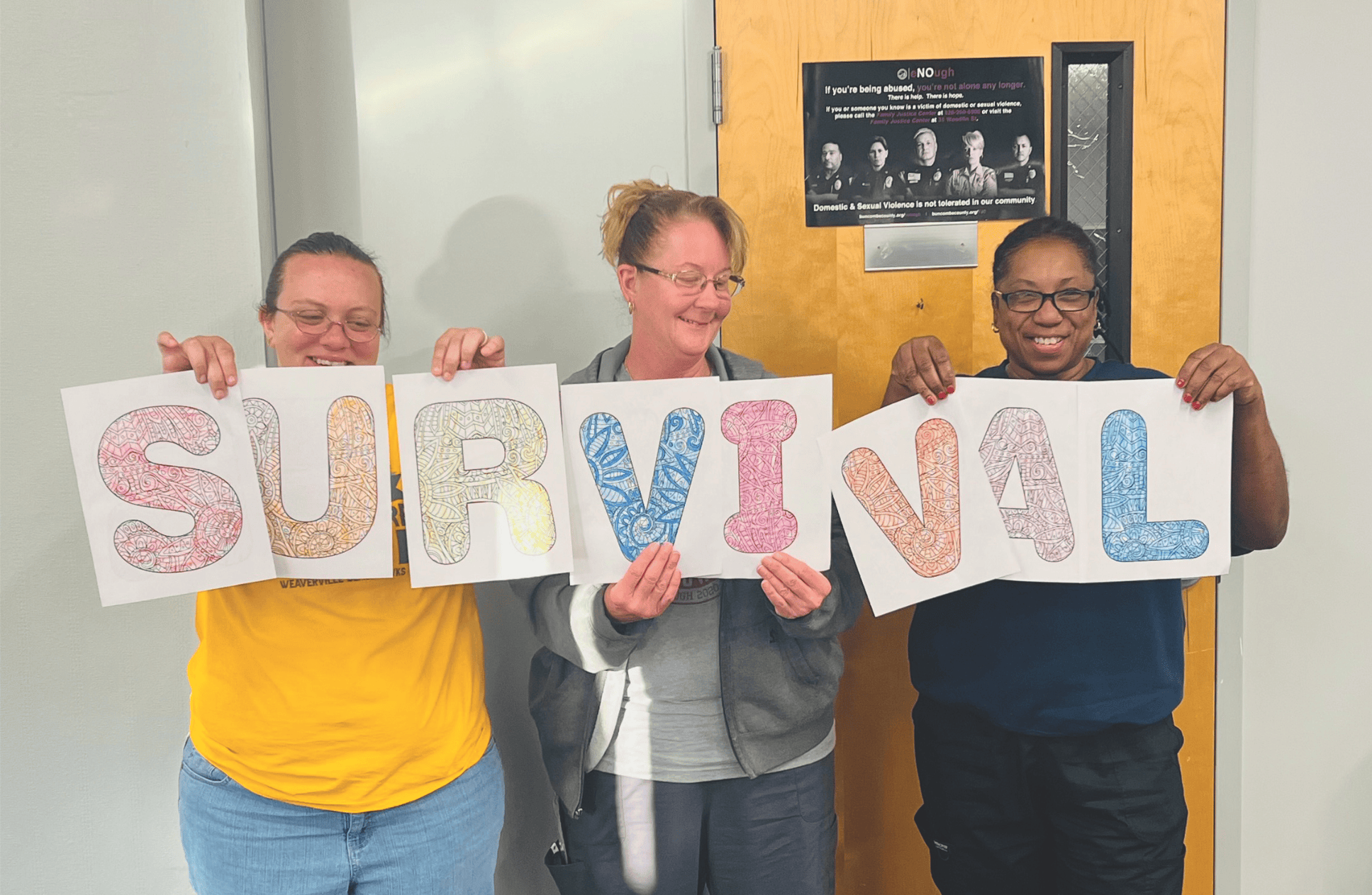 Buncombe County Schools staff holding letters that spell the word "survival"