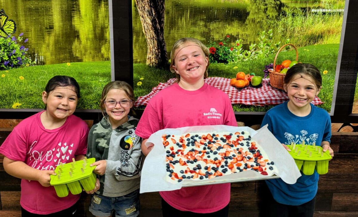 Warrick County School Corporation students pose with the food they made during a Little Chefs class