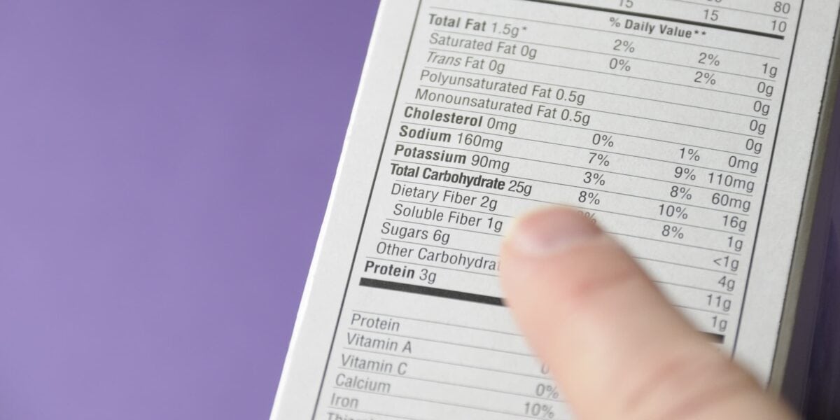 finger pointing at a food nutrition label