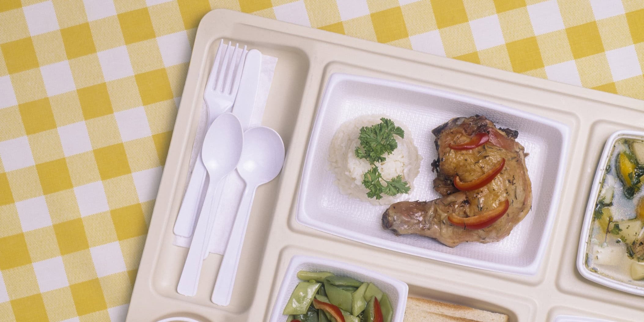 lunch tray with food on a yellow plaid background
