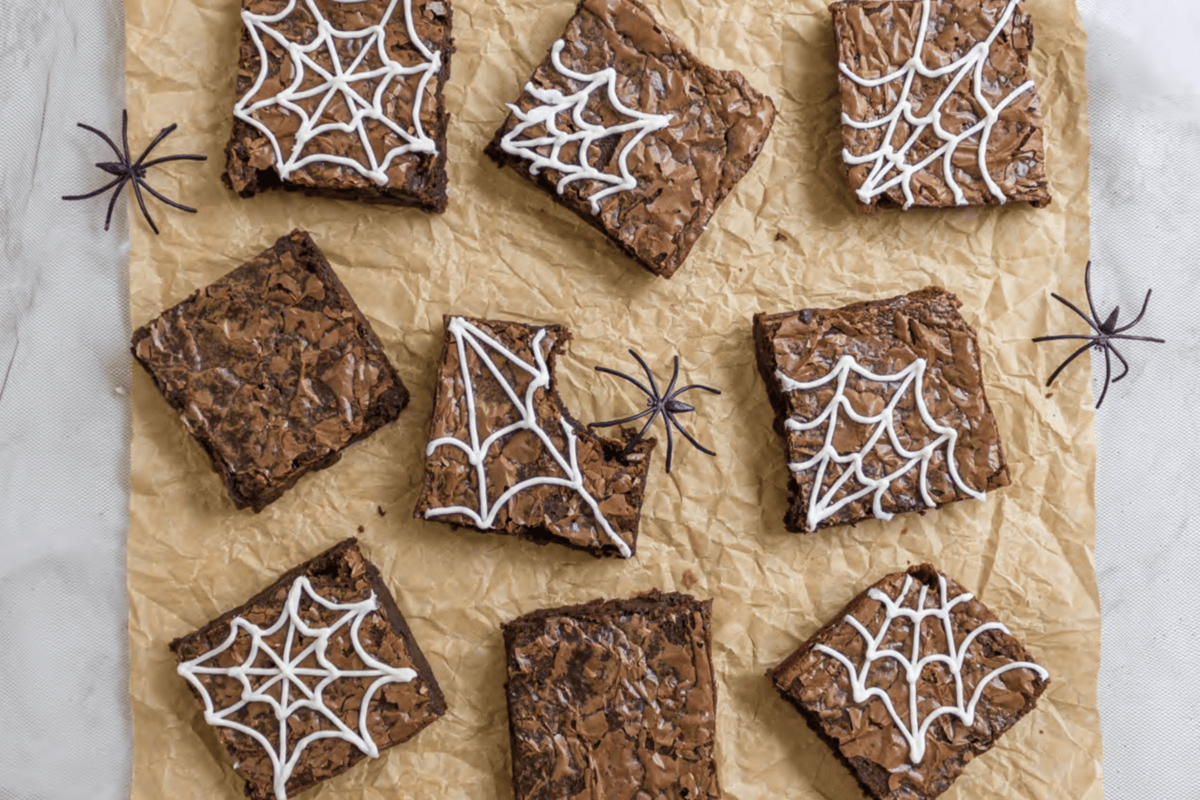 brownies with icing in a spider web design